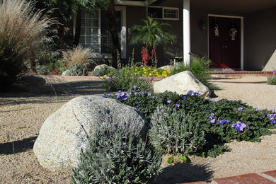 Photo of a mid-sized southwestern full sun front yard gravel landscaping in Orange County for spring.