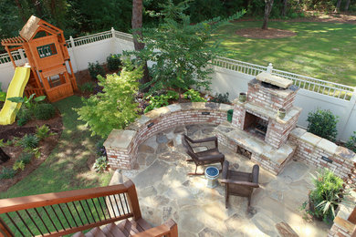 Photo of a small contemporary shade backyard stone landscaping in Atlanta with a fire pit for summer.
