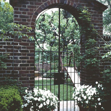 Brick Arched Garden Entry with Wrought Iron Gate