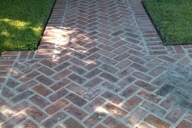 Design ideas for a mid-sized traditional shade backyard brick garden path in Los Angeles.