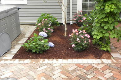 Inspiration for a small traditional partial sun backyard brick garden path in Boston.