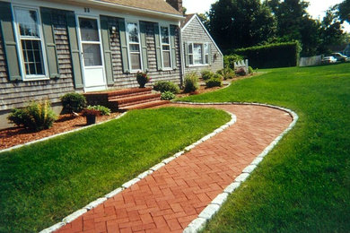 Photo of a mid-sized modern front yard brick garden path in Boston.