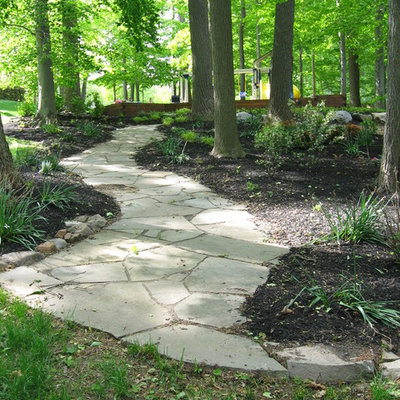 Inspiration for a large traditional backyard stone landscaping in Philadelphia.