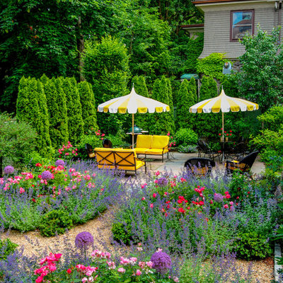Photo of a mid-sized traditional full sun side yard stone formal garden in Boston.