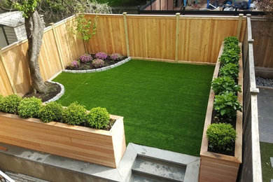 Photo of a small traditional partial sun backyard landscaping in New York.