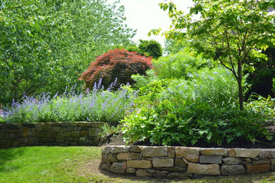 Design ideas for a mid-sized contemporary full sun front yard stone landscaping in Philadelphia for spring.