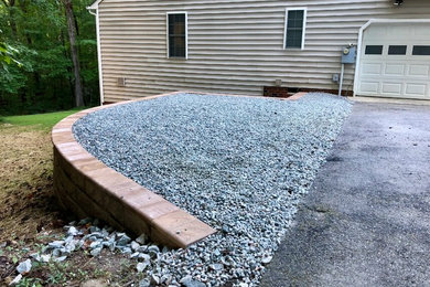 This is an example of a contemporary side yard retaining wall landscape in Richmond.
