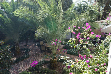 Photo of a traditional partial sun backyard brick formal garden in Orlando.