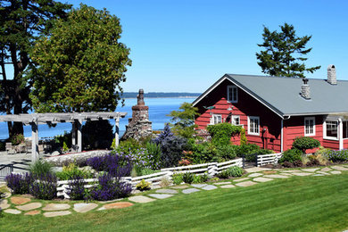 Photo of a large farmhouse full sun side yard stone garden path in Seattle.
