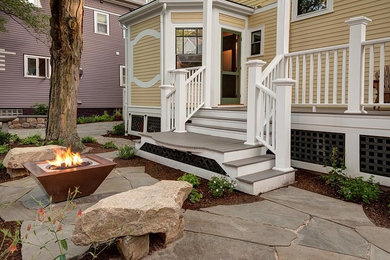 Medium sized classic front garden in Boston with a fire feature and natural stone paving.