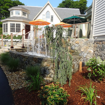 Cape Cod Inn with New England Stone Cladding, Retaining Walls, and Water Feature