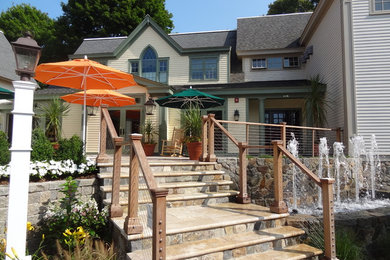 Cape Cod Inn with New England Stone Cladding, Retaining Walls, and Water Feature