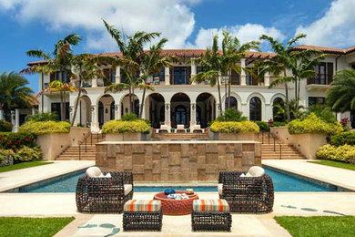 Inspiration for a huge mediterranean full sun backyard concrete paver landscaping in Miami.