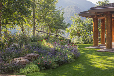 Inspiration for a huge rustic partial sun backyard landscaping in Denver for summer.
