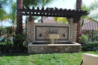 Photo of a large transitional backyard water fountain landscape in Los Angeles.