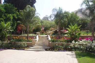 This is an example of a large mediterranean backyard brick landscaping in Los Angeles.
