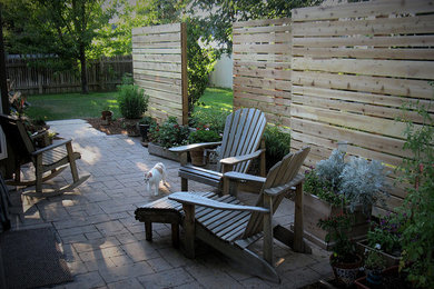This is an example of a medium sized contemporary back formal fully shaded garden in Boise with natural stone paving.