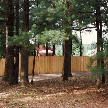 Cedar Solid Board Privacy Fence in a Wooded Area