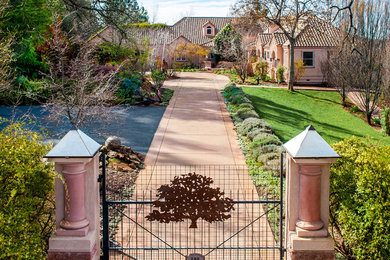 This is an example of a traditional partial sun front yard driveway in Sacramento.
