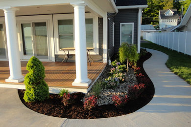Design ideas for a mid-sized traditional partial sun front yard concrete paver landscaping in New York.
