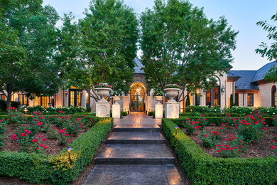 Photo of a large traditional front formal garden in Denver with a garden path.