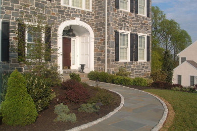 Photo of a mid-sized traditional full sun front yard stone formal garden in Philadelphia.