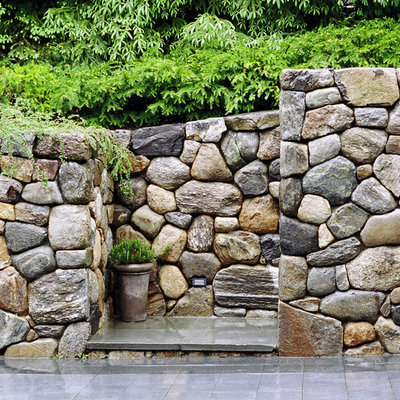 This is an example of a large traditional full sun backyard stone garden path in Boston.
