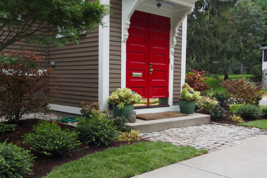 Design ideas for a mid-sized transitional partial sun front yard stone landscaping in Providence for spring.