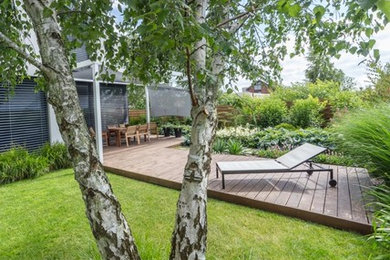 Inspiration for a small contemporary full sun backyard landscaping in Other with decking.