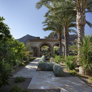 This is an example of a mediterranean backyard stone landscaping in Phoenix.