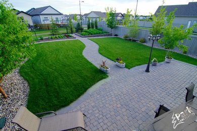 This is an example of a mid-sized full sun backyard brick landscaping in Edmonton.