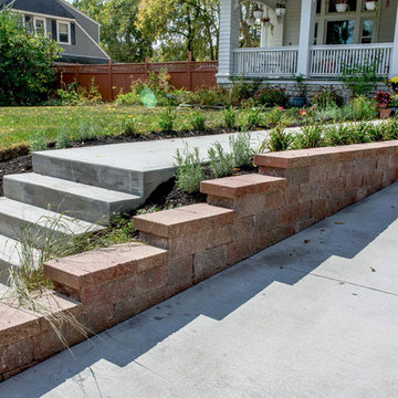 Clean Concrete Drive with Bold Brick Accent Retaining Walls