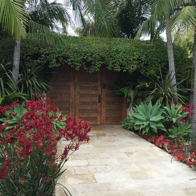 This is an example of a mid-sized tropical full sun front yard stone garden path in Los Angeles.