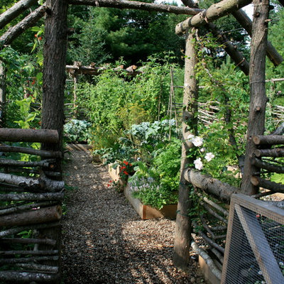 Photo of a large rustic full sun backyard gravel landscaping in Portland Maine.