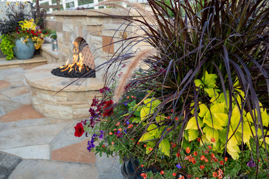 This is an example of a mid-sized southwestern full sun backyard stone landscaping in Other with a fire pit for summer.