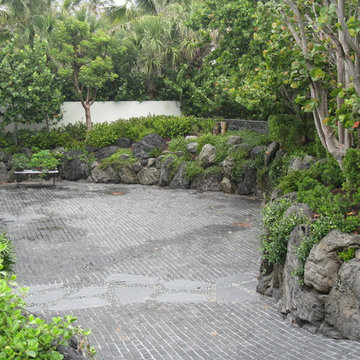 Cobblestone driveway  and rock garden walls