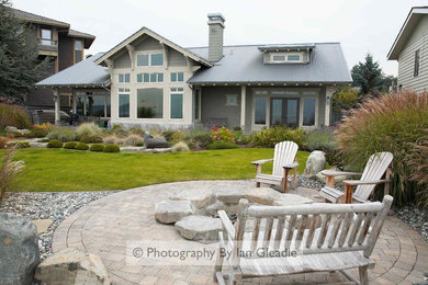 Photo of a mid-sized coastal partial sun backyard concrete paver landscaping in Seattle with a fire pit for summer.