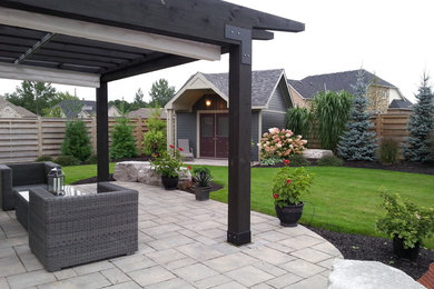 This is an example of a huge full sun backyard concrete paver landscaping in Toronto for fall.