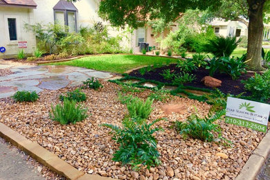 Inspiration for a mid-sized rustic shade front yard stone landscaping in Austin.