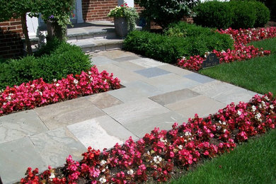 Photo of a medium sized classic front full sun garden in Chicago with a garden path and natural stone paving.
