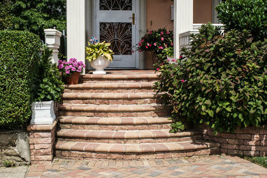 Design ideas for a mid-sized traditional front yard brick landscaping in New York.