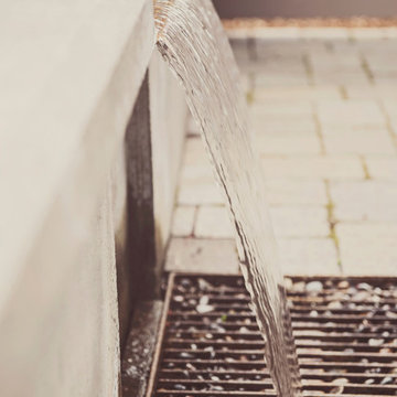 Concrete water feature with steel drainage grate