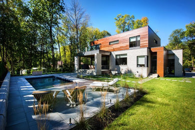 This is an example of a contemporary backyard concrete paver landscaping in Montreal for summer.