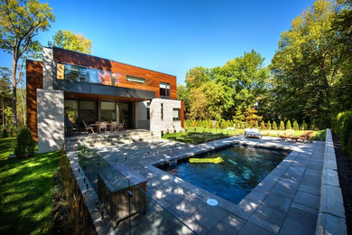 This is an example of a contemporary backyard concrete paver landscaping in Montreal for summer.