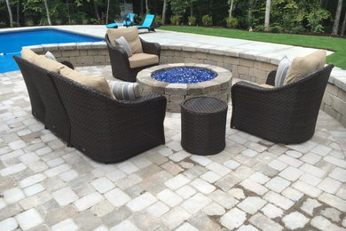 Inspiration for a large transitional full sun backyard concrete paver landscaping in Other with a fire pit.