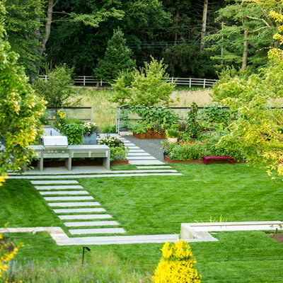 This is an example of a mid-sized contemporary partial sun backyard stone formal garden in New York.