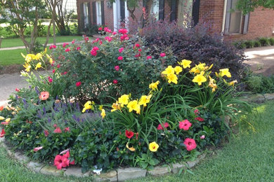 This is an example of a large craftsman partial sun front yard mulch landscaping in Dallas for spring.