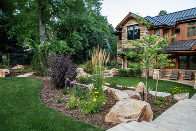 Design ideas for a traditional garden in Denver with a fire feature and natural stone paving.