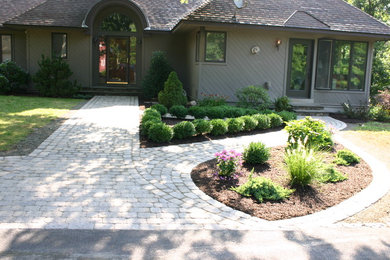 Inspiration for a mid-sized contemporary shade front yard brick landscaping in Bridgeport for summer.