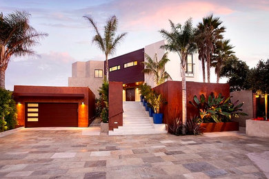This is an example of a large contemporary full sun courtyard stone driveway in Santa Barbara.